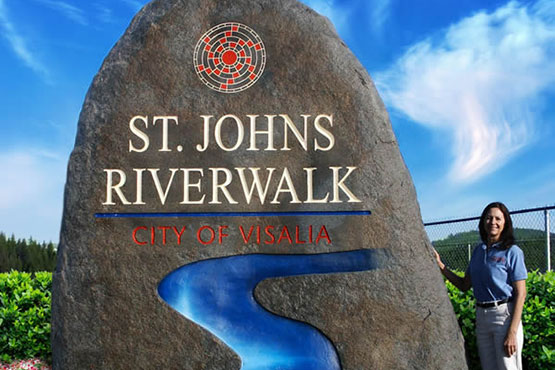 Large stone sign for Saint John's Riverwalk.